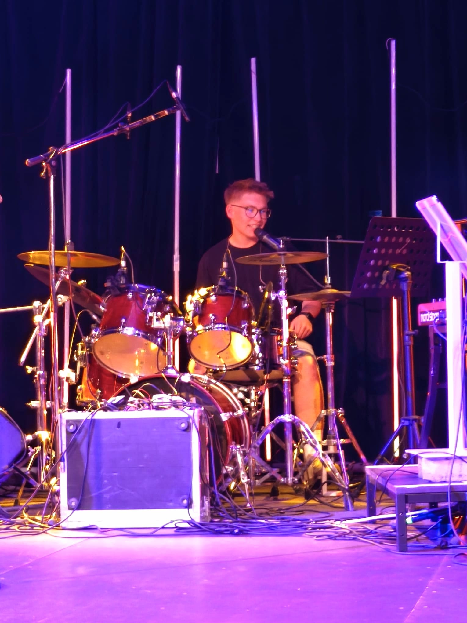 Drummer performing behind the kit